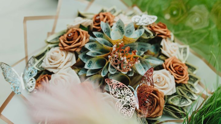 Artistic arrangement of roses and money in a bouquet, adorned with delicate butterflies.